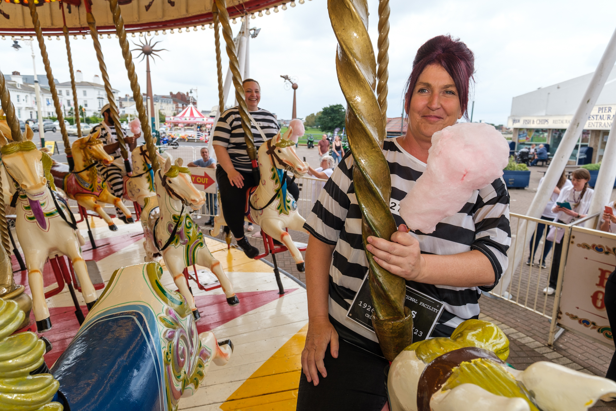 Jail and Bail for Queenscourt Hospice. Kate Sutcliffe on Silcock's Carousel. Photo by Dave Brown Photography for Stand Up For Southport 