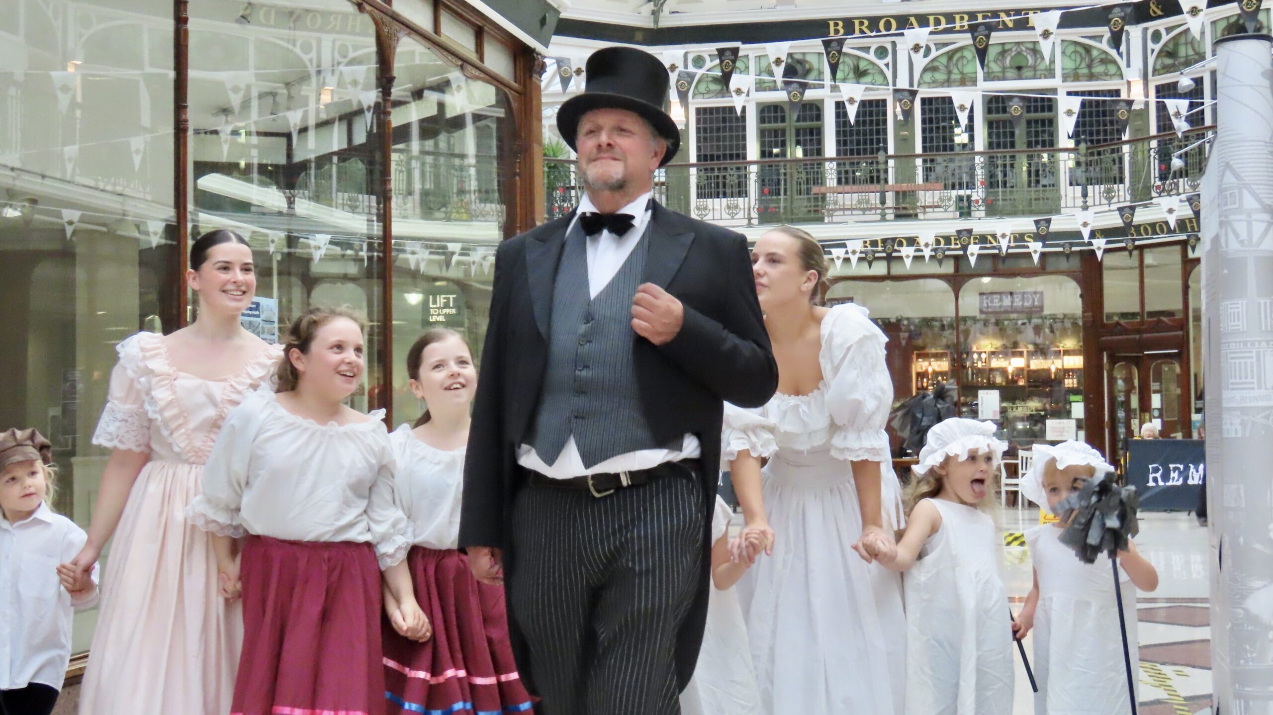 People are being invited to enjoy a very special Victorian Weekend as the historic Wayfarers Shopping Arcade in Southport celebrates its 125th anniversary.Master of Ceremonies Jordan Plunkett with children from the Alison Wright School of Dance and Drama. Photo by Andrew Brown Stand Up For Southport