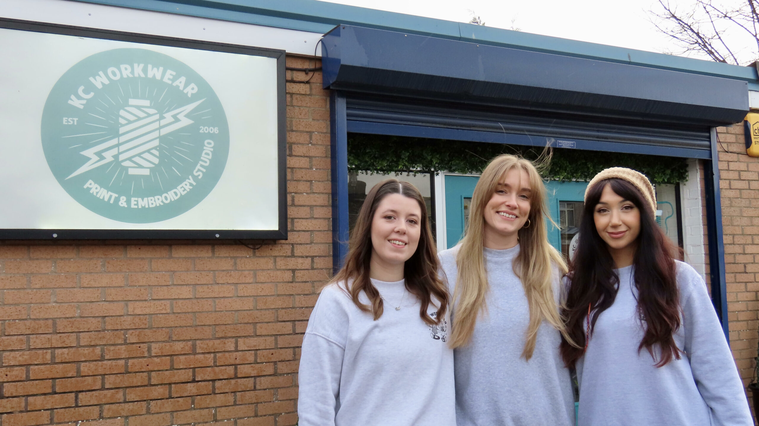 KC Workwear in Southport. Production Manager Zoe Thorpe; Print Technician Lauren Larkin; and Graphic Designer Amy Brooks. Photo by Andrew Brown Stand Up For Southport