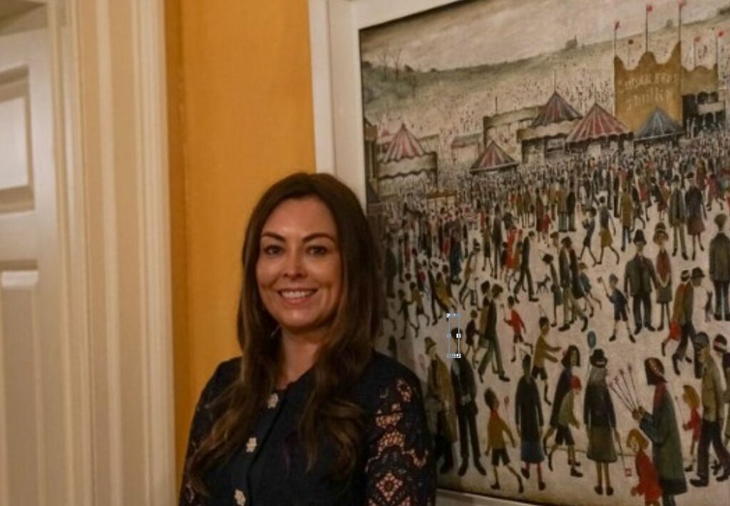 Serena Silcock-Prince with the world famous painting by artist LS Lowry inside 10 Downing Street in London - with the Silcock family name on the picture