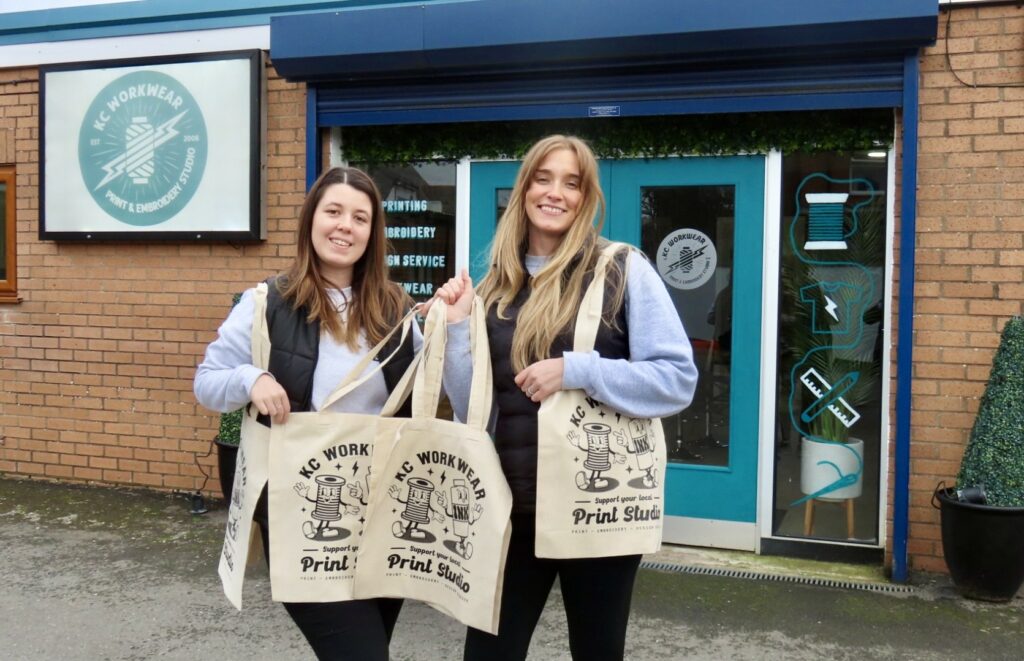 Graphic Designer Amy Brooks and Production Manager Zoe Thorpe with their new tote bags at KC Workwear in Birkdale in Southport. Photo by Andrew Brown Stand Up For Southport