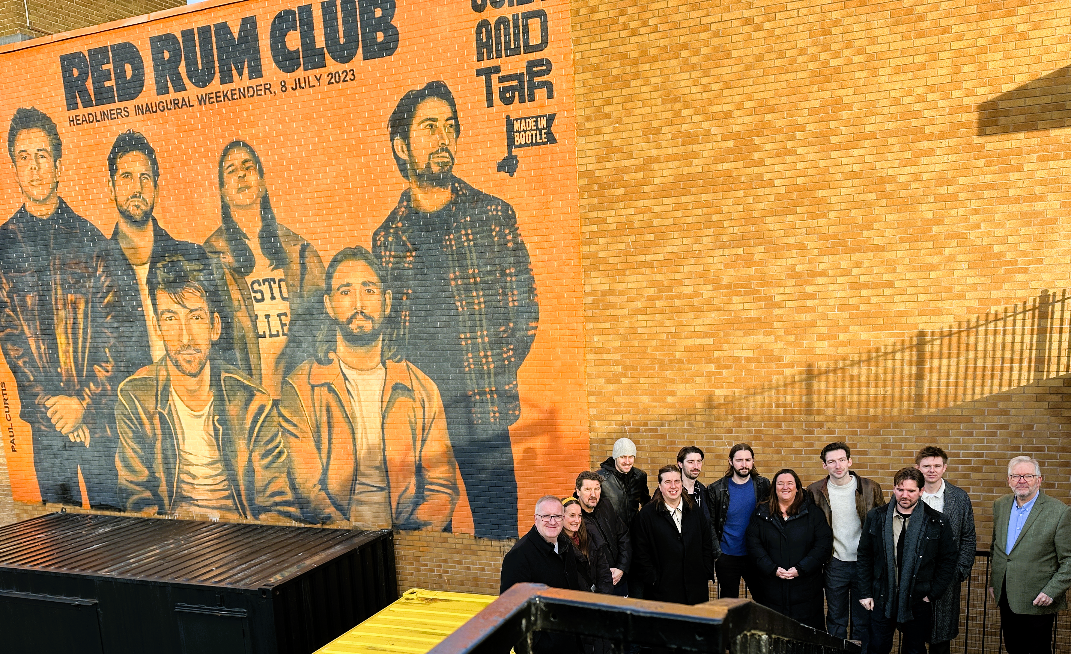 A new mural dedicated to local band Red Rum Club has been unveiled by Sefton Council at its Salt and Tar site in Bootle. It was created by Paul Curtis Artwork. l-r Stuart Barnes, Assistant Director Place, Karen Yates, Senior General Manager of Salt and Tar, George Wilson, Manager for Red Rum Club, Paul Curtis, artist, Jo Corby from RRC, Simon Hepworth from RRC, Neil Lawson from RRC, Cllr Atkinson, Francis Doran RRC, Mike McDermott RRC, Tom Williams RRC, Peter Dowd