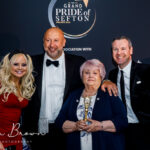 Southport Lifeboat founder Kath Wilson (third right) wins the 2023 Main Grand Pride Of Sefton Award. She is pictured with Mikhail hotel and Leisure Group Chairman Andrew Mikhail (second left) and hosts Claire Simmo (left) and Fraser Dainton (right). Photo by Kevin Brown Photography