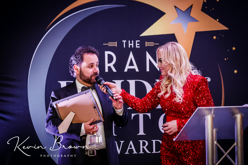 Barbara Rouse was awarded Sefton Courage Award at the 2024 Grand Pride Of Sefton Awards at The Grand in Southport by Peter Equizi from Capelli Hair Studio in Southport. Peter Equizi on stage with host Claire Simmo. Photo by Kevin Brown Photography