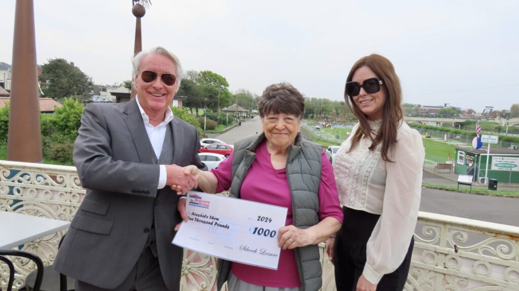 Herbert Silcock (left) and Serena Silcock-Prince (right) present a £1,000 cheque to Brenda Porter (centre) to support the 2024 Ainsdale Show