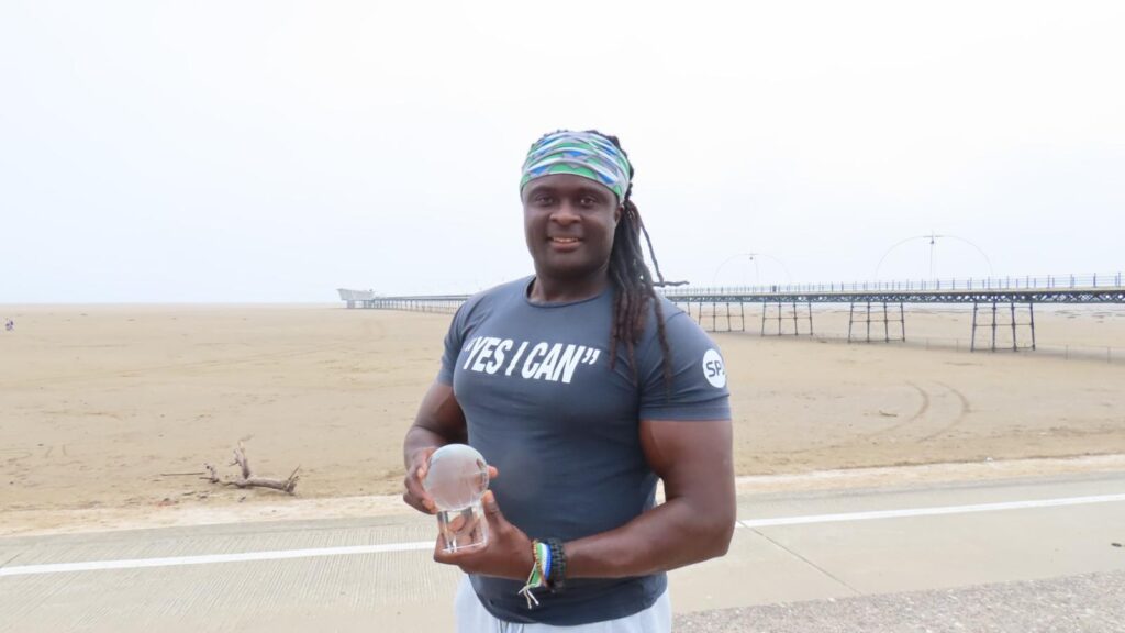 Inspirational speaker, author and tennis player Sam Jalloh at Southport Beach. Photo by Andrew Brown Stand Up For Southport