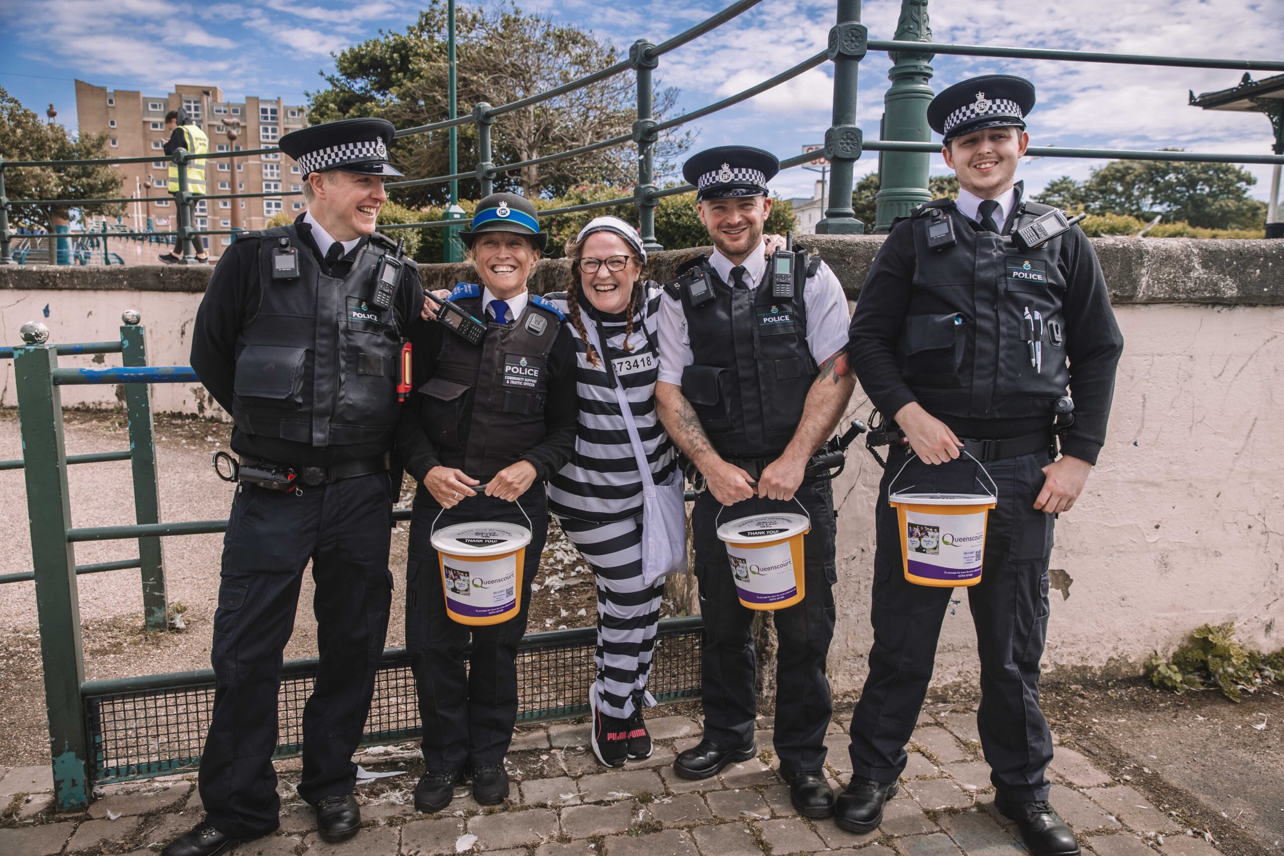 Twelve people have completed a bold escape from the cells at Southport Police Station in the annual Jail and Bail fundraiser for Queenscourt Hospice. Jocelyn Pye with Sefton Police officers 