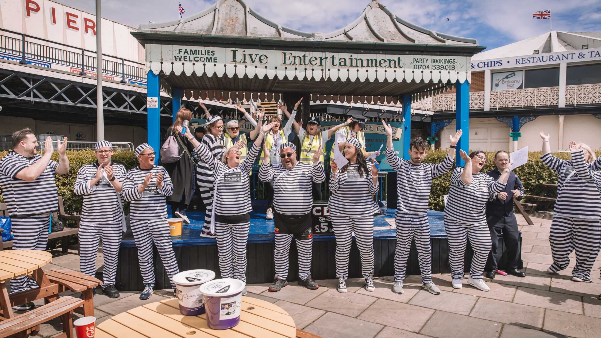 Twelve people have completed a bold escape from the cells at Southport Police Station in the annual Jail and Bail fundraiser for Queenscourt Hospice. Inmates enjoy karaoke at the Marine Lake Cafe in Southport 