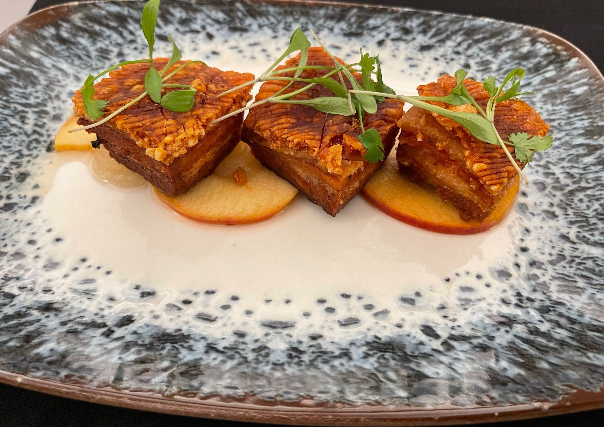 Teryiaki pork belly with pickled apples and apple gel at Harry's rooftop bar and terrace at The Grand Southport