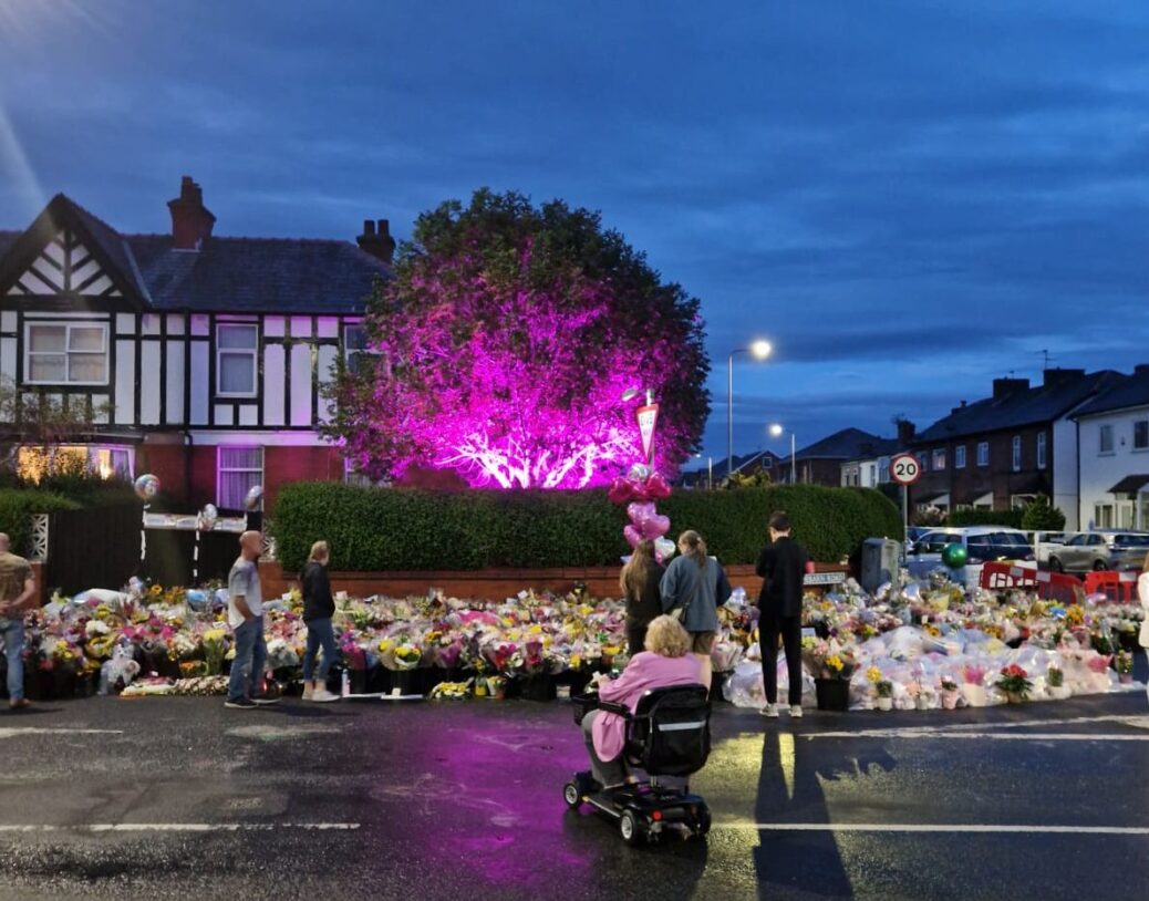 A tree in a house on Hart Street in Southport has been lit up pink by IllumiDex in memory of the girls who died in the Hart Street tragedy in Southport