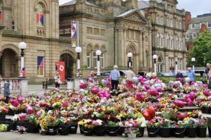 People lay tributes in the Town Hall Gardens in Southport after the Southport Tragedy. Photo by Andrew Brown Stand Up For Southport