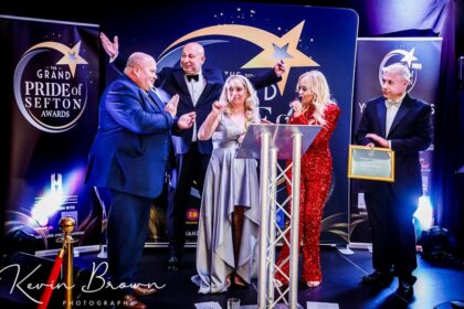 Denise Fergus was the Main winner of the 2024 Grand Pride Of Sefton Awards at The Grand Southport. She was joined on stage by husband Stuart as she collected the award from Mikhail Hotel And Leisure Group Chairman Andrew Mikhail, Stand Up For Southport Director Andrew Brown and In Demand Radio presenter and Awards host Claire Simmo. Photo by Kevin Brown Photography