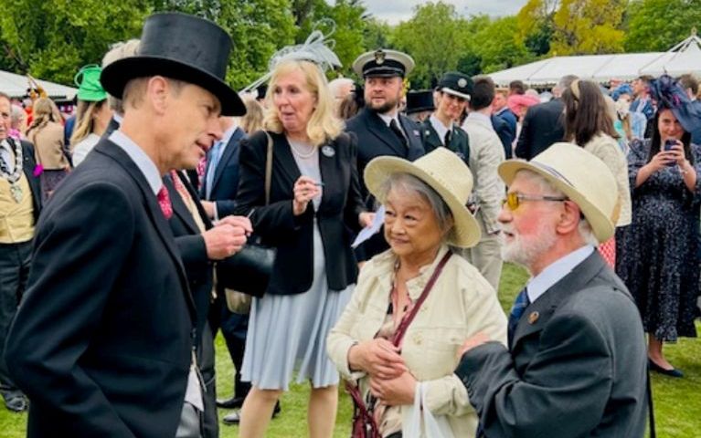 Prince Edward chatting with Kevin and Mary Dunne, the founders of the Stem Cell Scousers, at a Garden Party at Buckingham Palace