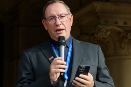 Rev Martin Abrams leads the vigil at the Town hall gardens in Southport after the Southport tragedy. Photo by Andrew Brown Stand Up For Southport