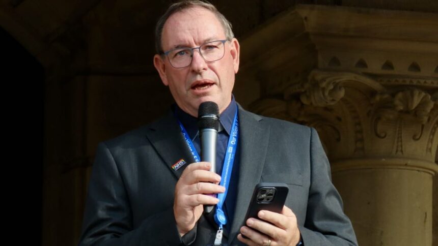Rev Martin Abrams leads the vigil at the Town hall gardens in Southport after the Southport tragedy. Photo by Andrew Brown Stand Up For Southport