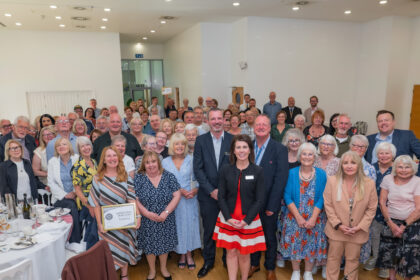 Councillor Steve Foulkes, Chair of the LCRCA Transport Committee & Neil Grabham, Managing Director of Merseyrail together with volunteers taking part in Merseyrail in Bloom 2025.