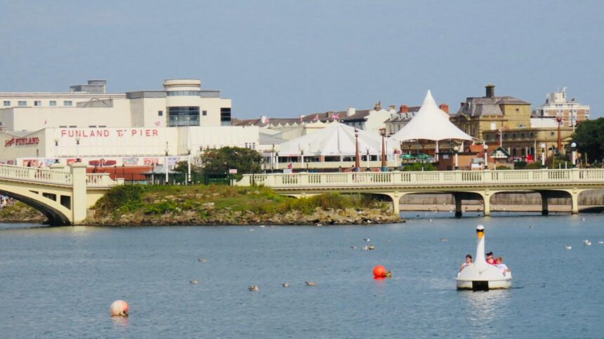 A scenic picture of sunny Southport, with the Marine Lake, the Venetian Bridge, Silcock's Carousel and Funland, and Kings Gardens. Photo by Andrew Brown Stand Up For Southport