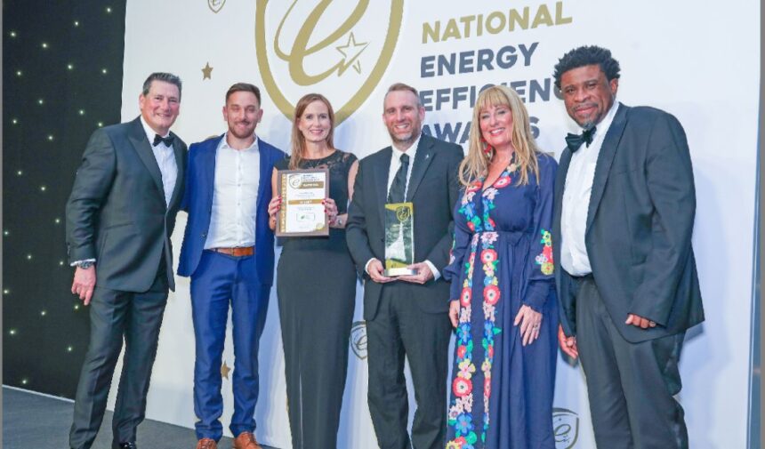 Making Energy Greener is celebrating earning national recognition in two categories at the Energy Efficiency Awards 2025 in Birmingham. They are pictured on stage with Soanday Ballet star Tony Hadley (left) Photo by Jason Mitchell Photography