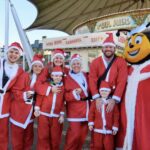 Supporters gather for the Southport Santa Sprint for Queenscourt Hospice outside Silcock's Funland and Carousel. Photo by Andrew Brown Stand Up For Souhtport
