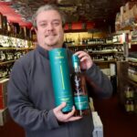 Portland Wine Cellars in Southport. Owner Phil Barber with a bottle of 16 year old Glenfiddich. Photo by Andrew Brown Stand Up For Southport