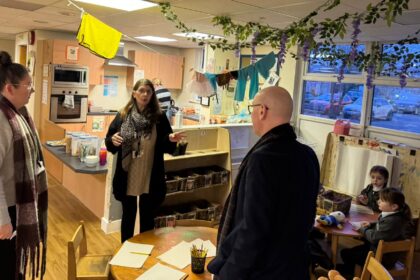 Southport MP Patrick Hurley discussing Bishop David Shepherd Breakfast Club alongside acting headteacher, Ms Pilkington, and staff