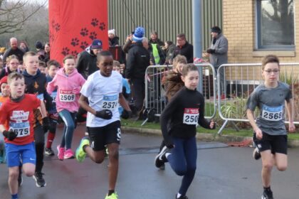 Competitors in the Pups Race at the Mad Dog 10K run in Southport. Photo by Andrew Brown Stand Up For Southport