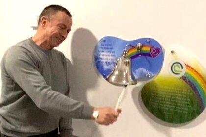 Patient Paul Dooley ringing the end of treatment bell at The Clatterbridge Cancer Centre
