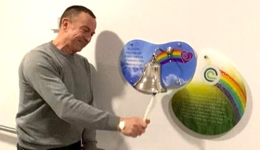 Patient Paul Dooley ringing the end of treatment bell at The Clatterbridge Cancer Centre