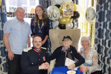 Former Royal Marine Stan Woolley has celebrated his 100th birthday at Ivy Gate Lodge Care Home in Southport. Guests included Merseyside Lord Lieutenant Peter Oliver OBE and Southport Royal British Legion President Serena Silcock-Prince, pictured with Stan's niece Jackie Ryan and her husband George. Photo by Andrew Brown Stand Up For Southport