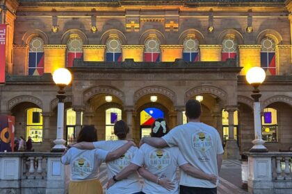 Bebe's Hive supporters in front of The Atkinson in Southport which was lit yellow in honour of Bebe King
