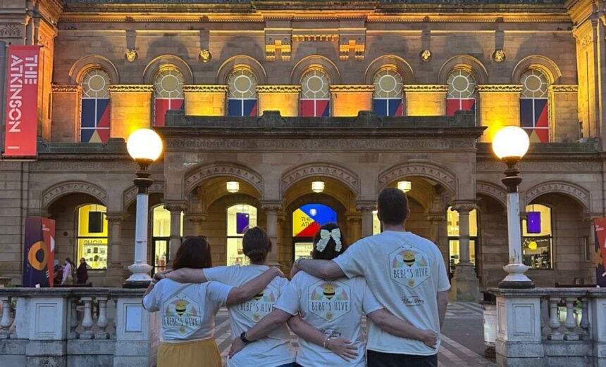 Bebe's Hive supporters in front of The Atkinson in Southport which was lit yellow in honour of Bebe King