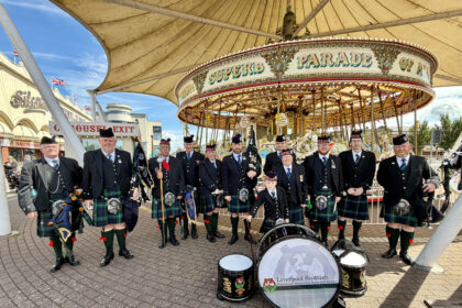 The Liverpool Scottish Regimental Pipes and Drums next to Silcock's Carousel in Southport, where they performed during Southport Armed Forces Day. Photo by Andrew Brown Stand Up For Southport