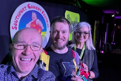 Southport New Comedian Of The Year 2025 Winner Rich McCulloch with Isabelle Kent from Dragon Soop and Festival Director Bren Riley