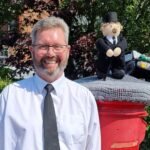 Michael Rushton with the knitted postbox topper from Southport Hookers outside the funeral home