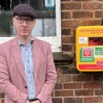Patrick Hurley MP next to a defibrillator