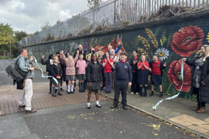 The longest mural in the UK has been completed by Paul Curtis at Cinder Path in Bootle as part of Sefton's School Neighbourhood project